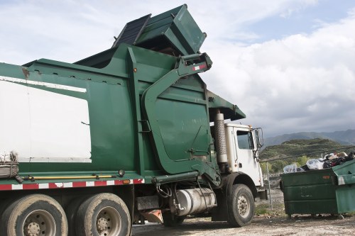 Worker removing garden debris with safety gear